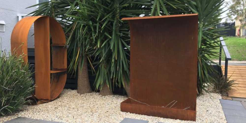 Corten steel wood stacker with corten steel fireplace