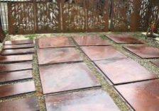 Sheets of Corten steel lying on a front yard.