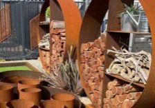 Corten steel wood stacker with chop woods